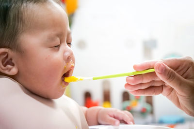 Close-up portrait of boy eating food