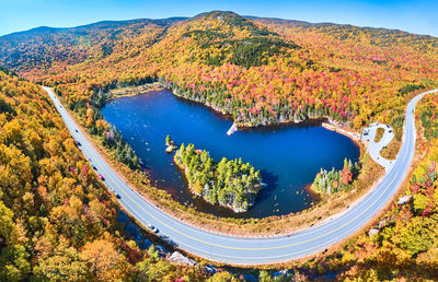 High angle view of road amidst trees against sky