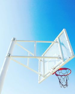 Low angle view of basketball hoop against clear blue sky