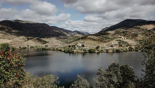 Scenic view of lake and mountains against sky