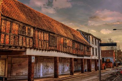 Houses against cloudy sky