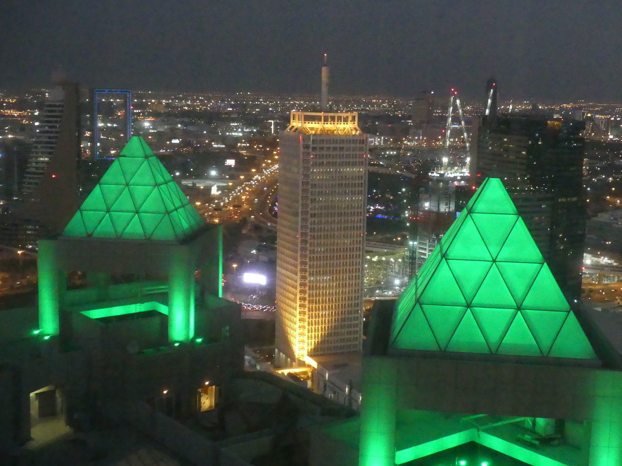 ILLUMINATED CITY BUILDINGS AT NIGHT