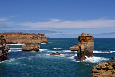 Scenic view of rock formation in sea against sky