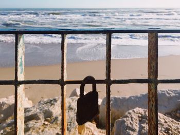 View of sea seen through metal railing