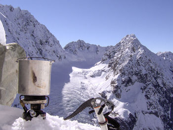 Scenic view of snowcapped mountains against clear blue sky