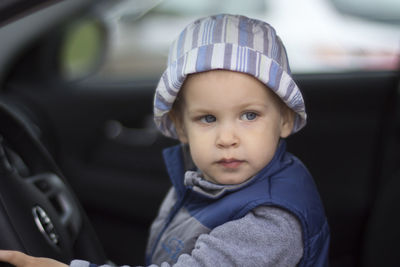Portrait of cute baby girl in car