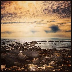 Scenic view of sea against cloudy sky