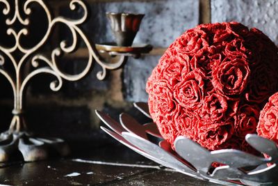 Close-up of red rose on table