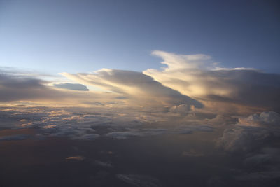 Aerial view of snowcapped mountains against sky during sunset