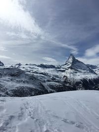 Scenic view of snowcapped mountains against sky