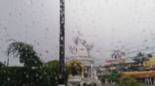 Buildings seen through wet window during rainy season