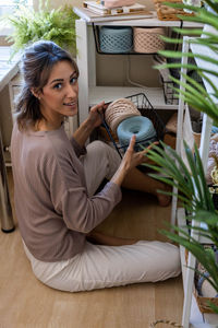 Young woman sitting on sofa at home