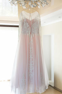 Wedding dress hanging at home