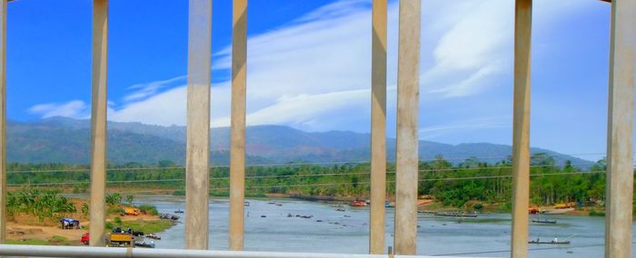 Scenic view of sea and mountains against sky