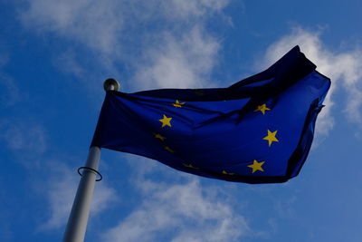 Low angle view of european union flag against blue sky