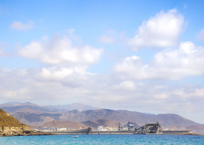 Scenic view of sea and mountains against sky