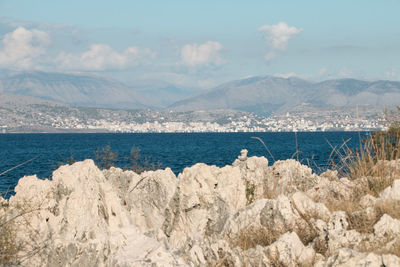 Scenic view of sea and mountains against sky