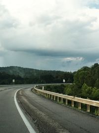 Empty road with mountain range in background