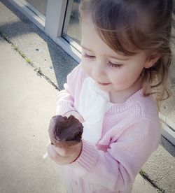 High angle view of cute girl holding ice cream outdoors