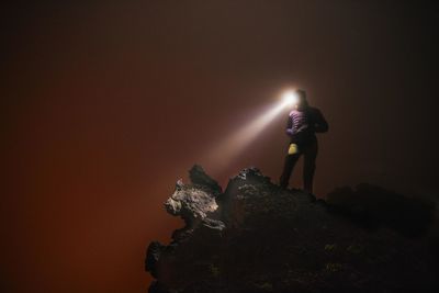 Woman with headlight at night