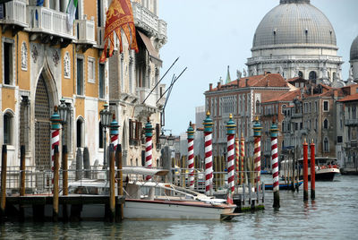 Boats in canal amidst buildings in city