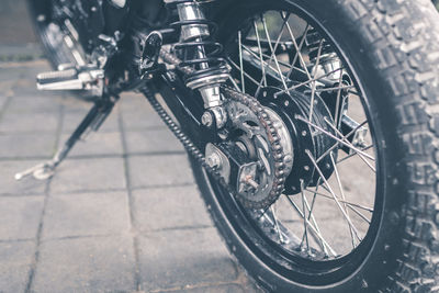 Close-up of motor bike on footpath