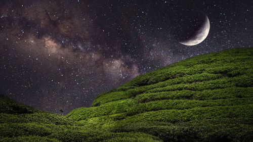 Scenic view of mountains against sky at night