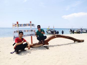 People on beach against sky