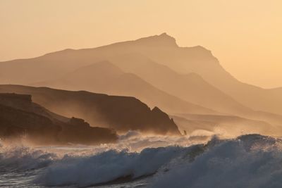 Scenic view of mountains and sea during sunset