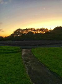 Scenic view of field against sky during sunset