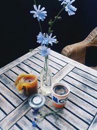 High angle view of flowers in vase by coffee mug on table