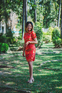 Portrait of smiling young woman standing outdoors