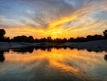 Scenic view of lake against romantic sky at sunset