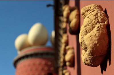 Low angle view of pastries against clear blue sky