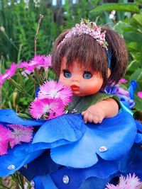 Portrait of girl on purple flowering plant