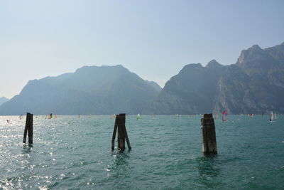 Scenic view of sea and mountains against clear sky