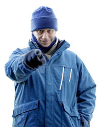 Portrait of man standing against white background