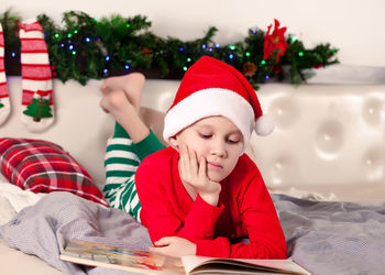 High angle view of girl playing with christmas tree