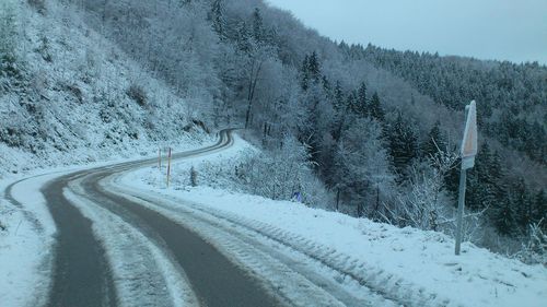 Road amidst snow covered trees