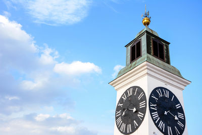 Low angle view of bell tower against sky