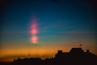 Low angle view of silhouette buildings against sky at sunset