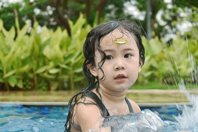 Close-up of cute girl splashing in water
