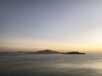 Scenic view of sea against clear sky during sunset