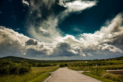 Empty road along countryside landscape