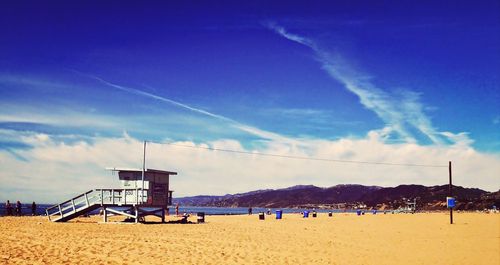 Scenic view of beach against blue sky