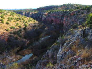 Scenic view of river amidst mountains against sky