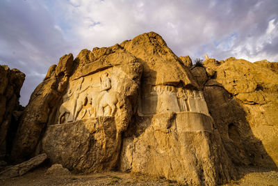 Low angle view of rock formation against sky  at persepolis