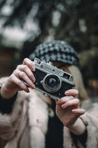 Midsection of woman photographing with camera