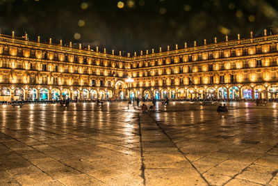 Illuminated building at town square during night