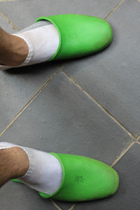 High angle view of man wearing green shoes